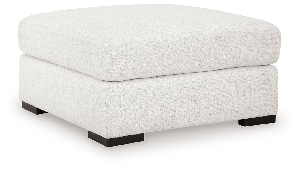 Oversized accent ottoman in chalk with cushioned rounded top and black base feet