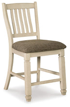 Beige upholstered barstool with slatted backrest and padded seat, dark fabric cushion