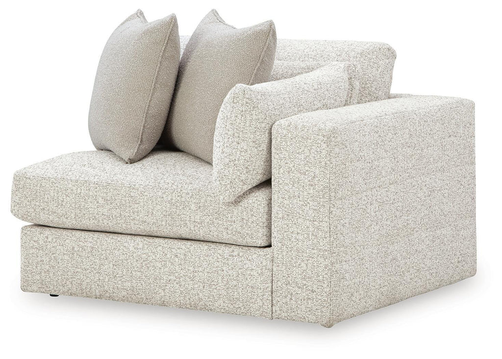 Light grey upholstered corner chair with two bolstered back cushions and seat cushion