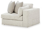Light grey upholstered corner chair with two bolstered back cushions and seat cushion