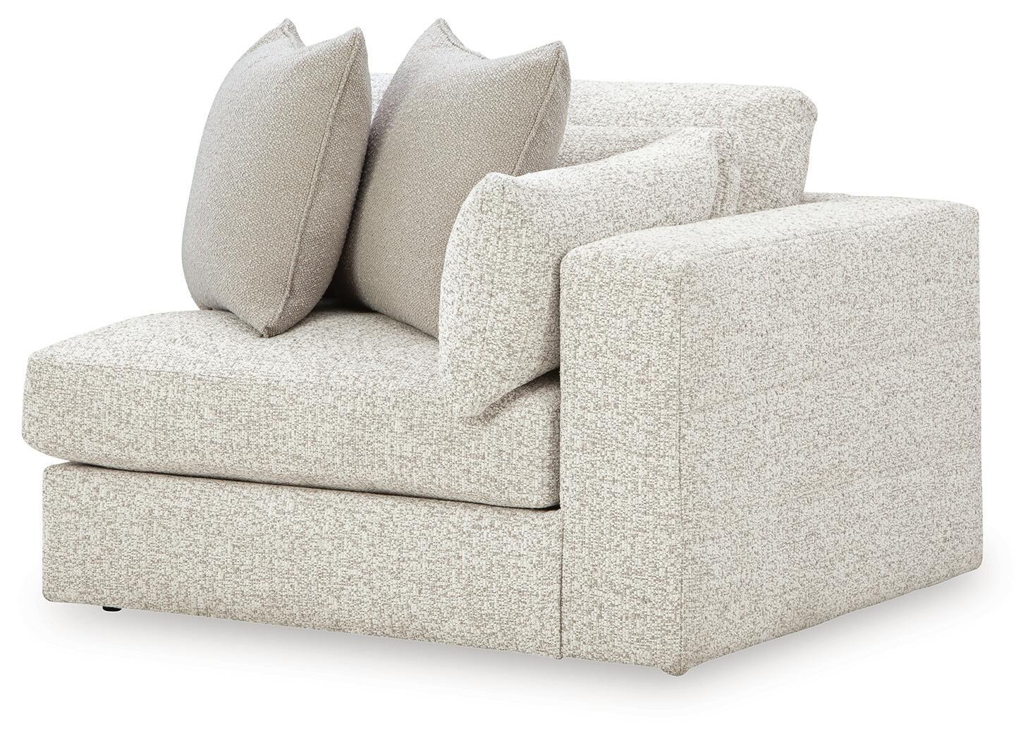 Light grey upholstered corner chair with two bolstered back cushions and seat cushion