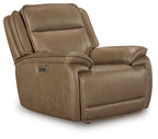 Brown power recliner chair with adjustable headrest and padded arms, side view
