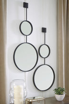 Wall-mounted mirror set with three oval mirrors on black bar frames.