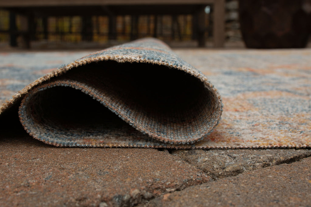 5' x 7' rug close-up: bound edge with low-pile distressed blue and orange texture
