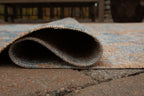5' x 7' rug close-up: bound edge with low-pile distressed blue and orange texture