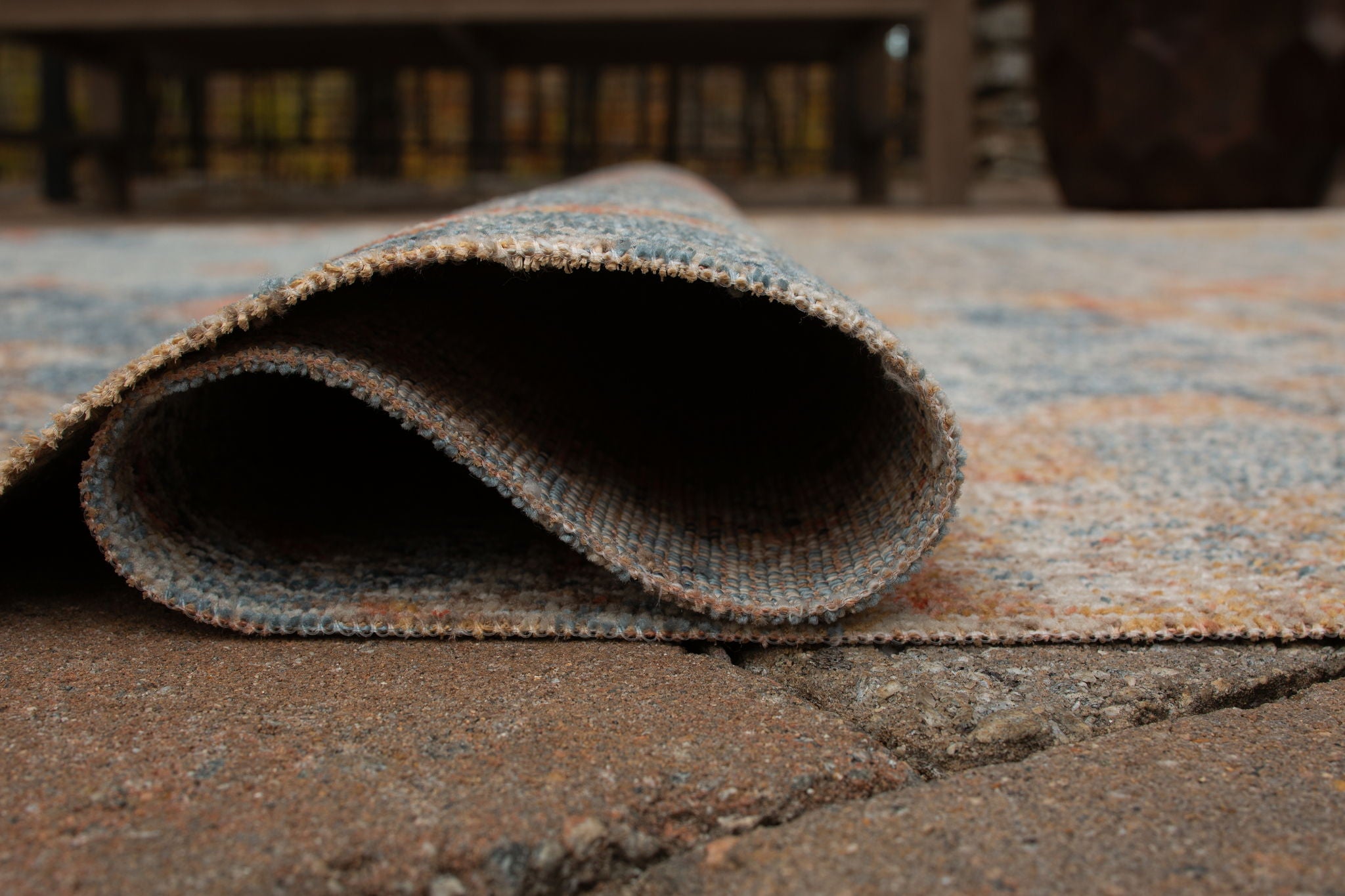 5' x 7' rug close-up: bound edge with low-pile distressed blue and orange texture