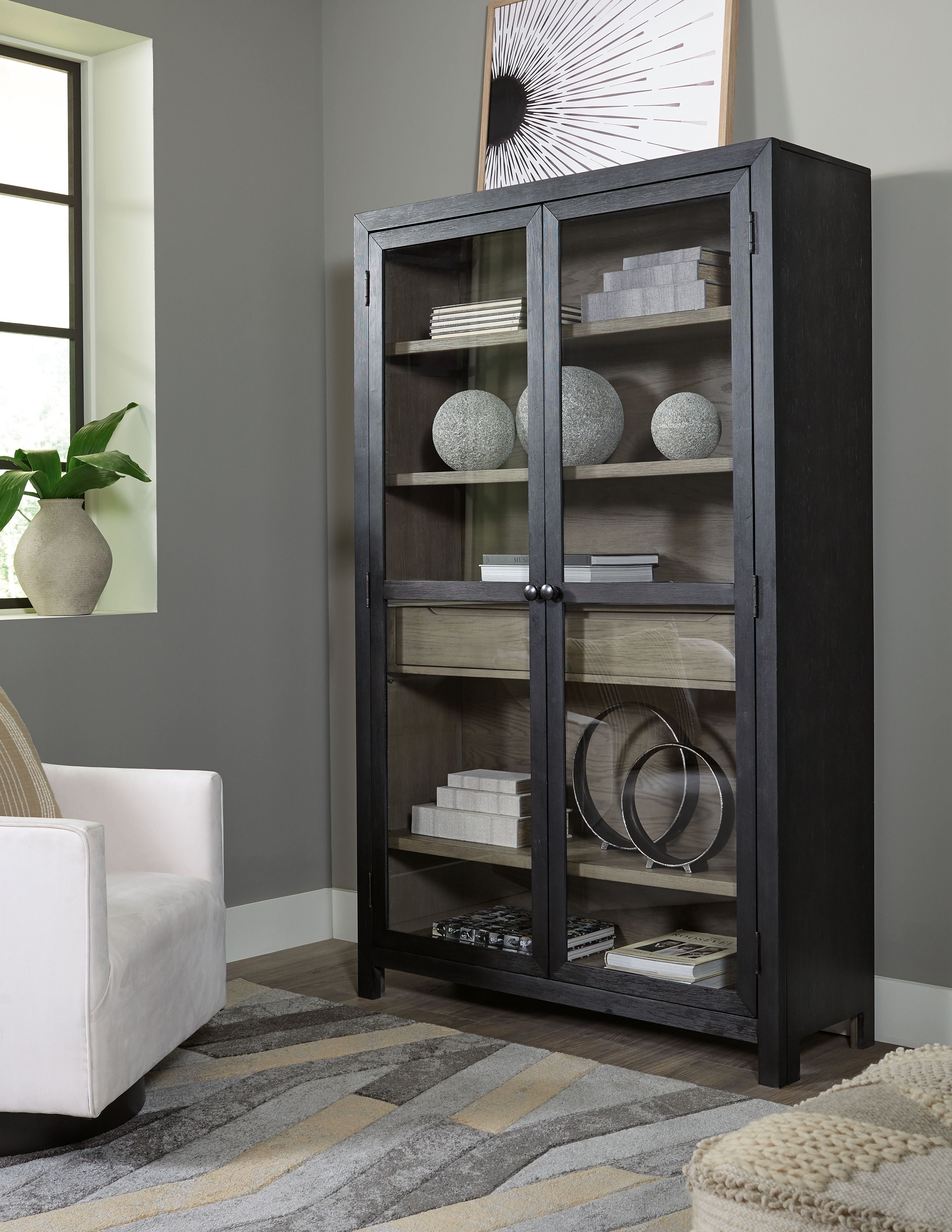 Dark gray accent cabinet with two doors and interior shelves, metal knob pulls