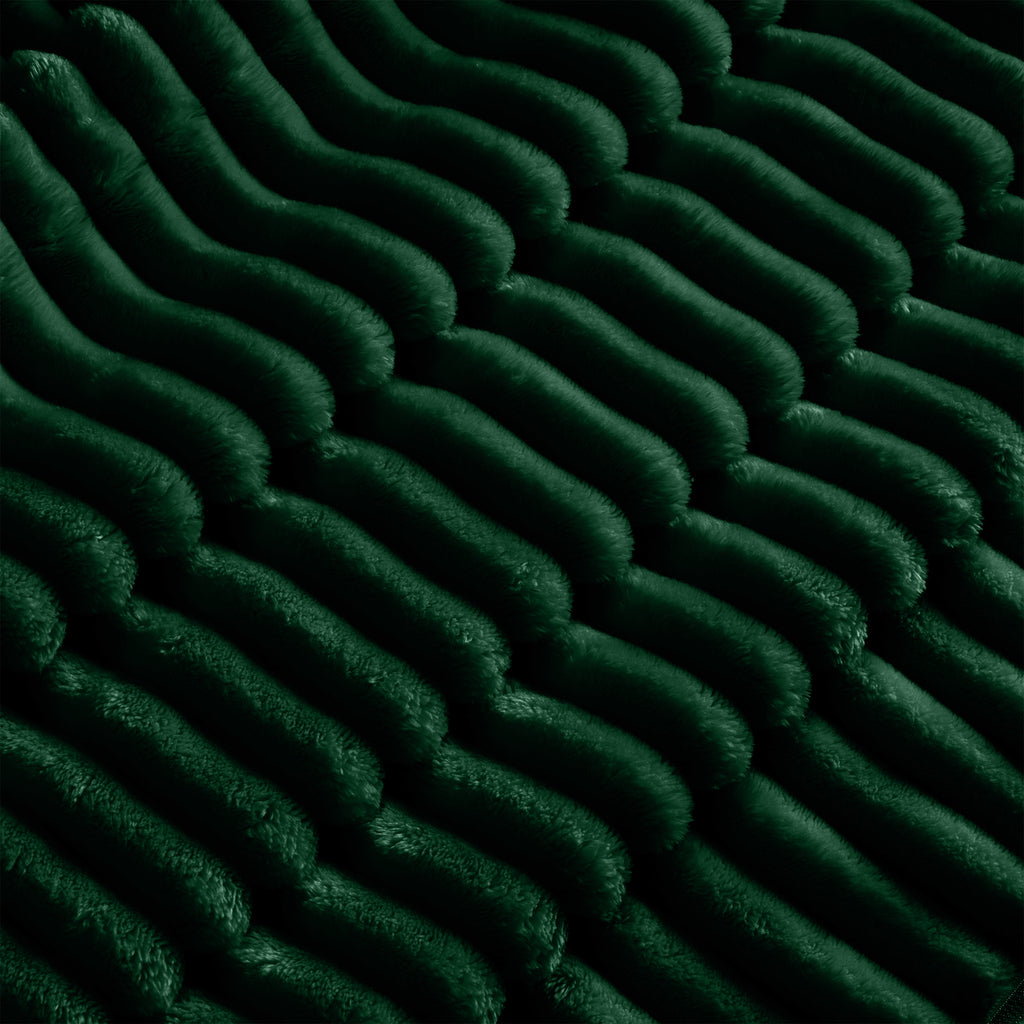 Close-up of green ribbed slipcover fabric on sectional cushions