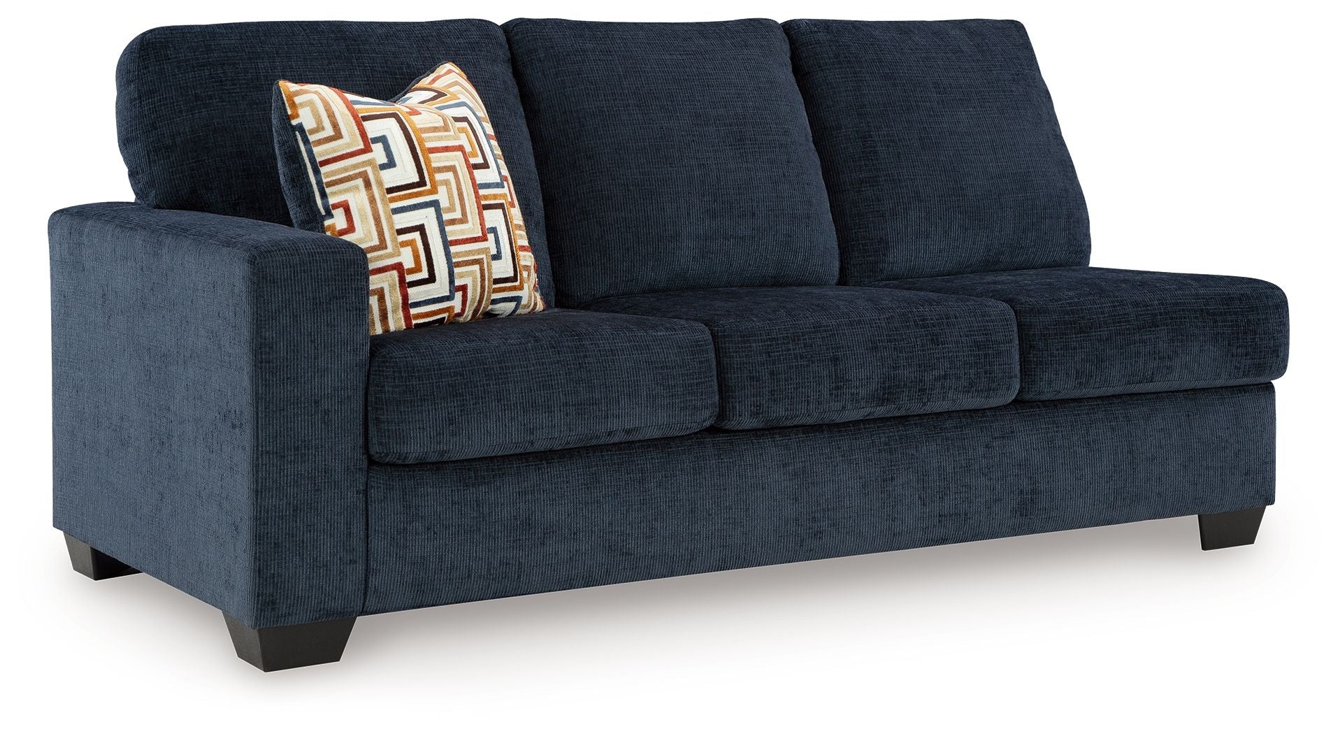Ink blue fabric sofa with square arms, three seat cushions, and patterned throw pillow