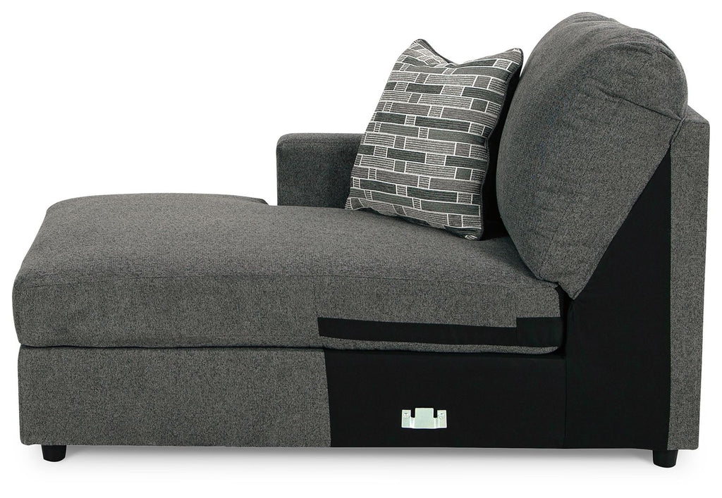 Dark gray corner chaise with backrest and gray-and-white patterned throw pillow