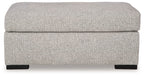 Light gray upholstered ottoman with rounded cushioned top and dark legs