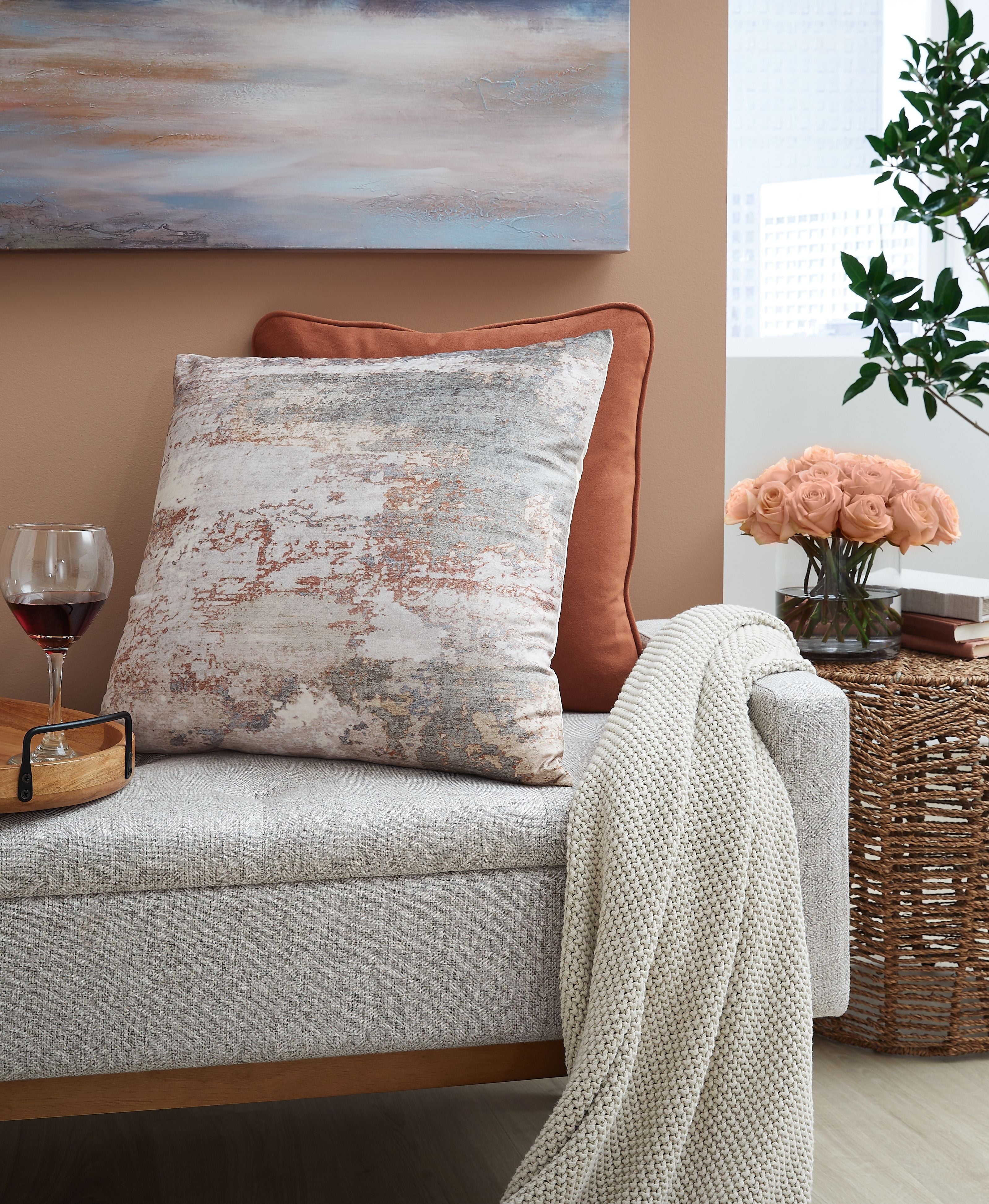 Gray and rust distressed throw pillow on sofa