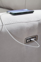 Light gray sofa armrest with charging port and connected cable