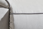 Light gray sofa arm and armrest seam with textured upholstery