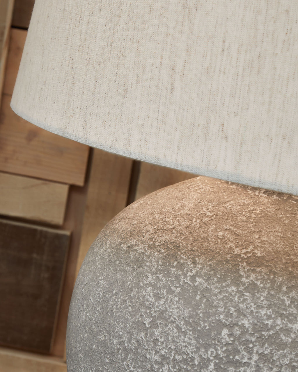 Distressed gray lamp base texture under paper shade fabric