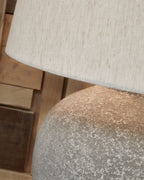 Distressed gray lamp base texture under paper shade fabric