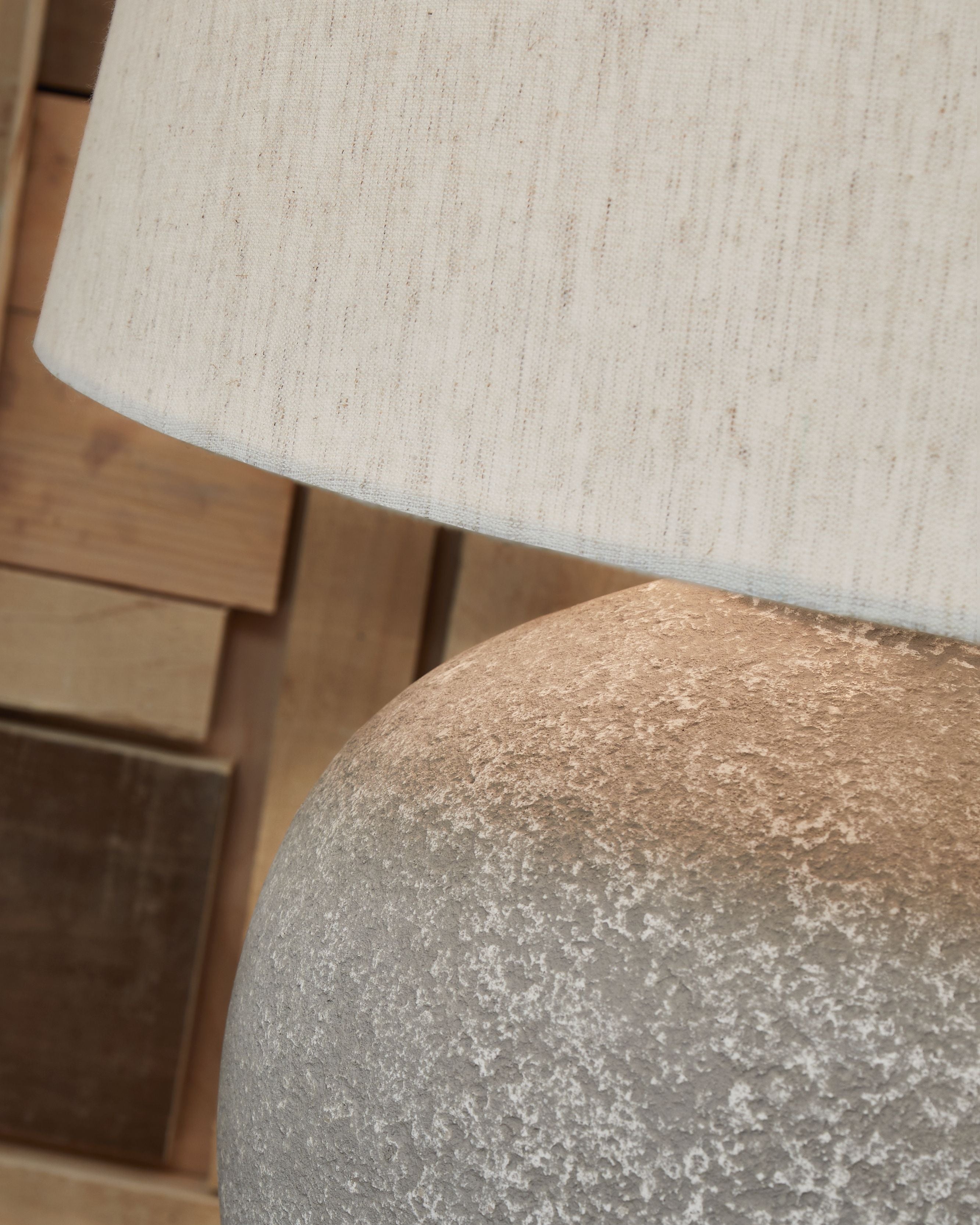 Distressed gray lamp base texture under paper shade fabric