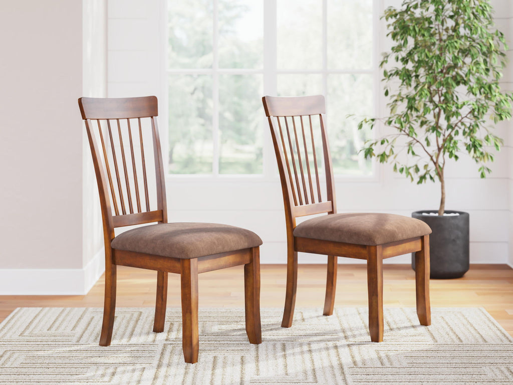 Pair of dining side chairs in rustic brown wood with slatted backs and cushioned seats