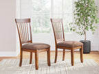 Pair of dining side chairs in rustic brown wood with slatted backs and cushioned seats