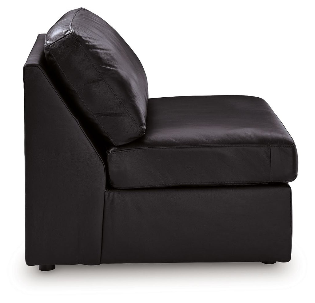 Black armless accent chair with curved back and arm-free sides, leather-look upholstery.