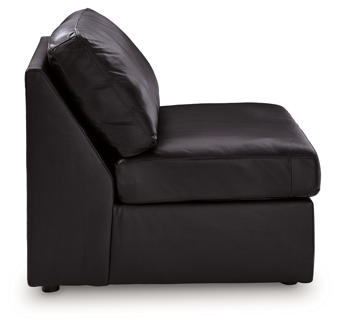 Black armless accent chair with curved back and arm-free sides, leather-look upholstery.