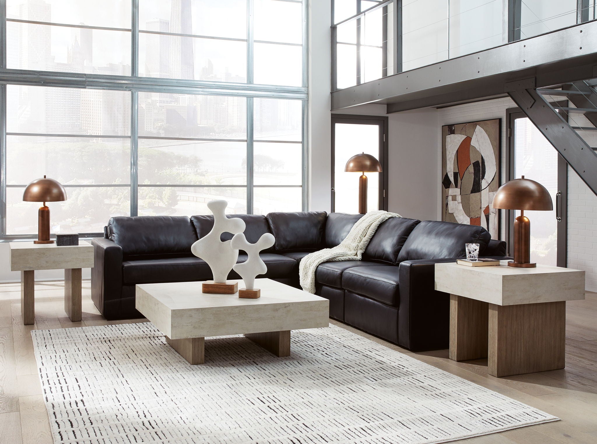 Black sectional sofa with chaise, tufted cushions, and throw pillows