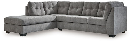 Dark gray L-shaped sectional sleeper sofa with deep tufted cushions and chaise end