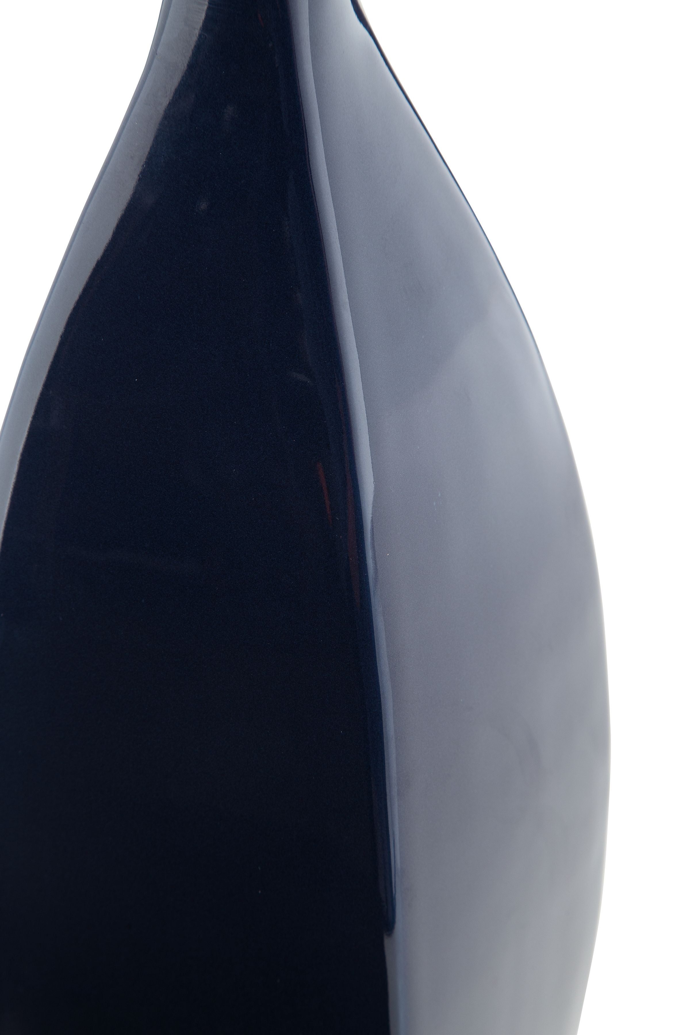 Close-up of blue ceramic vase with glossy dark front panel and lighter side