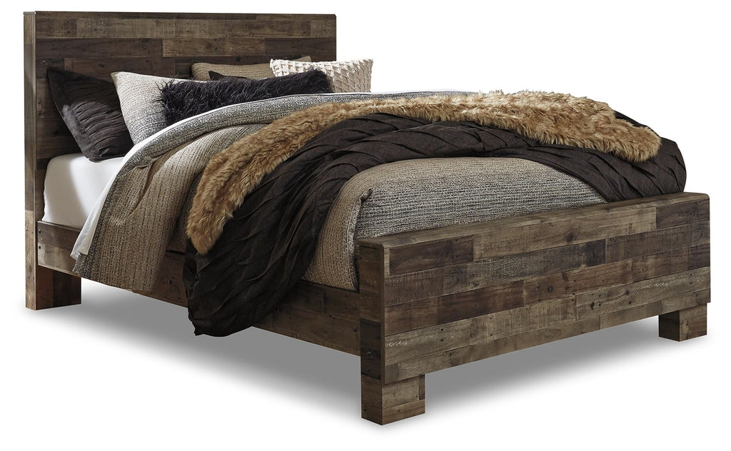 Dark gray panel bed with fur throw and layered bedding, side view with foot board
