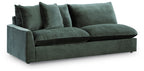 Jade green upholstered sectional sofa with three seat cushions and tall back pillows
