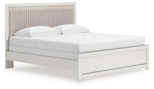 White upholstered panel bed with tall channel-tufted headboard and two white pillows