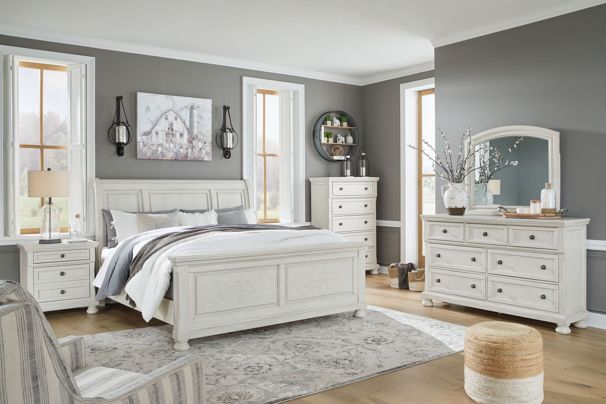 White sleigh bed set with dresser and arched mirror in bedroom
