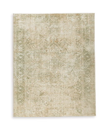 Beige distressed patterned area rug with subtle vintage motifs