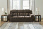 Dark brown reclining sofa with tufted back panels, rounded arms, and cushioned seat