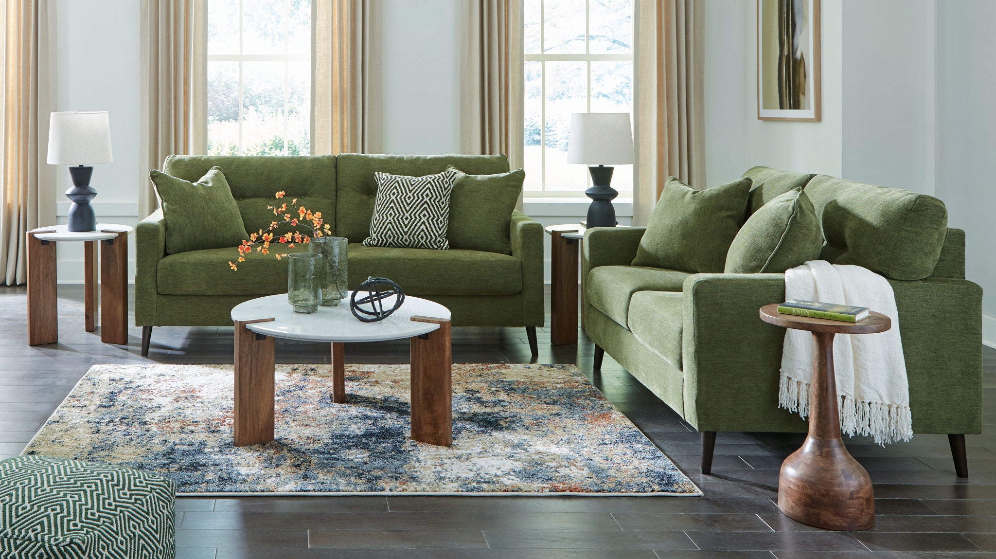 Green upholstered sofa set with two matching seating pieces and assorted throw pillows