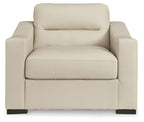 Almond upholstered armchair with high backrest, padded seat, and dark legs