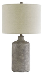 Ceramic table lamp with off-white fabric shade and textured dark base