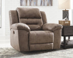 Fossil power recliner with reclining back and raised footrest, taupe fabric upholstery