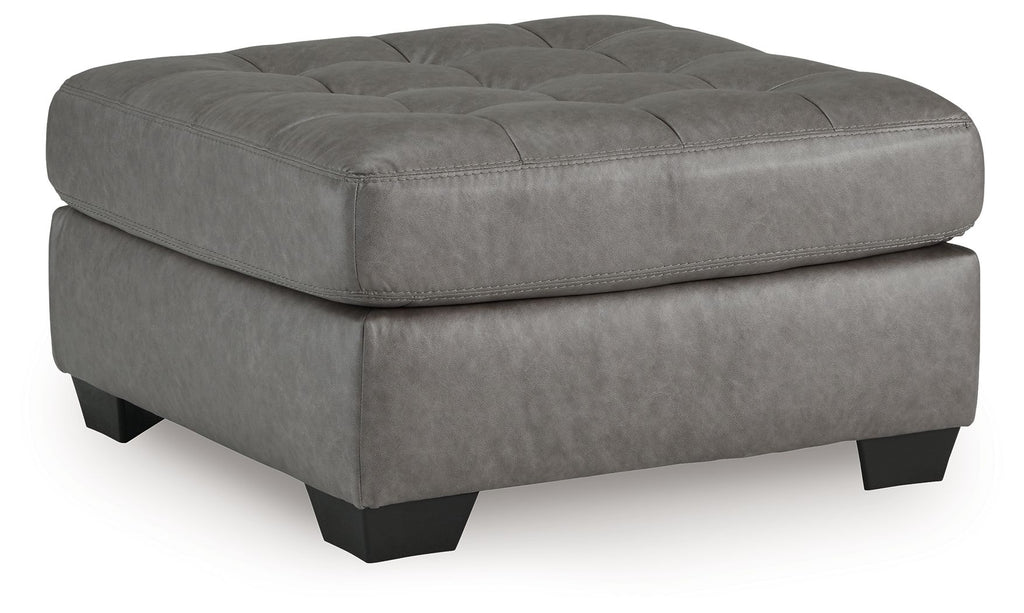 Oversized accent ottoman in gray with tufted top and black legs