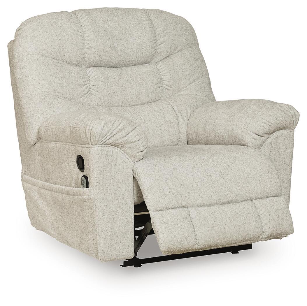 Light beige upholstered recliner with thick headrest, button-tufted back, and angled seat