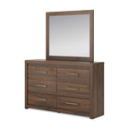 Light brown dresser with tall mirror frame and six drawers with bar pulls.