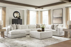 Beige sectional sofa with chaise lounge, multiple seat sections, and decorative throw pillows