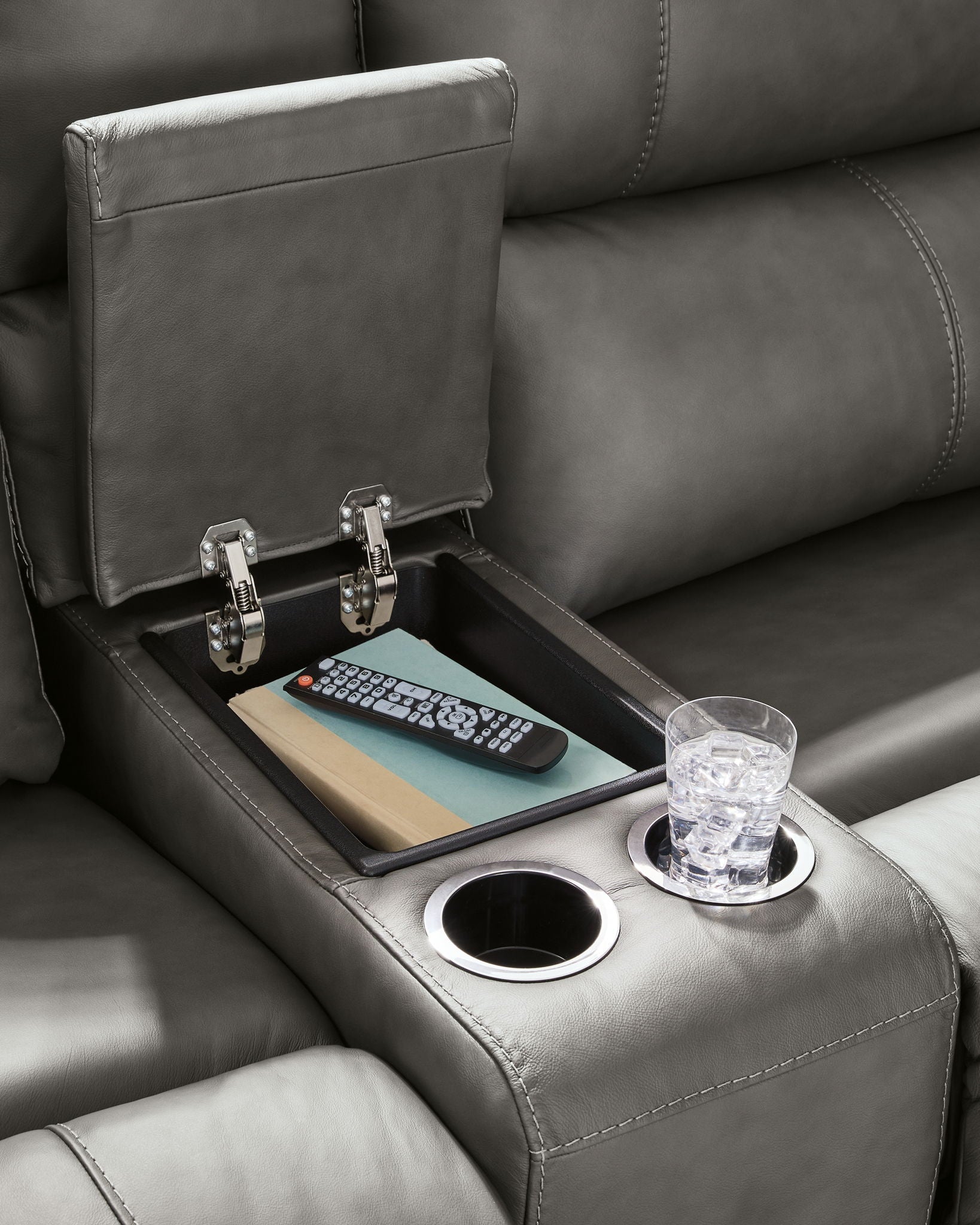 Power reclining sectional sofa console with cup holders and control switches on the arm