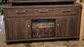 Dark brown TV stand with fireplace insert, two drawers and two door cabinets