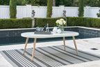 White oval dining table with tapered legs and oval tabletop