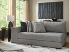 Gray corner chaise with striped throw and three decorative pillows