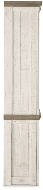 Distressed tall pier cabinet with raised panel door and dark top trim