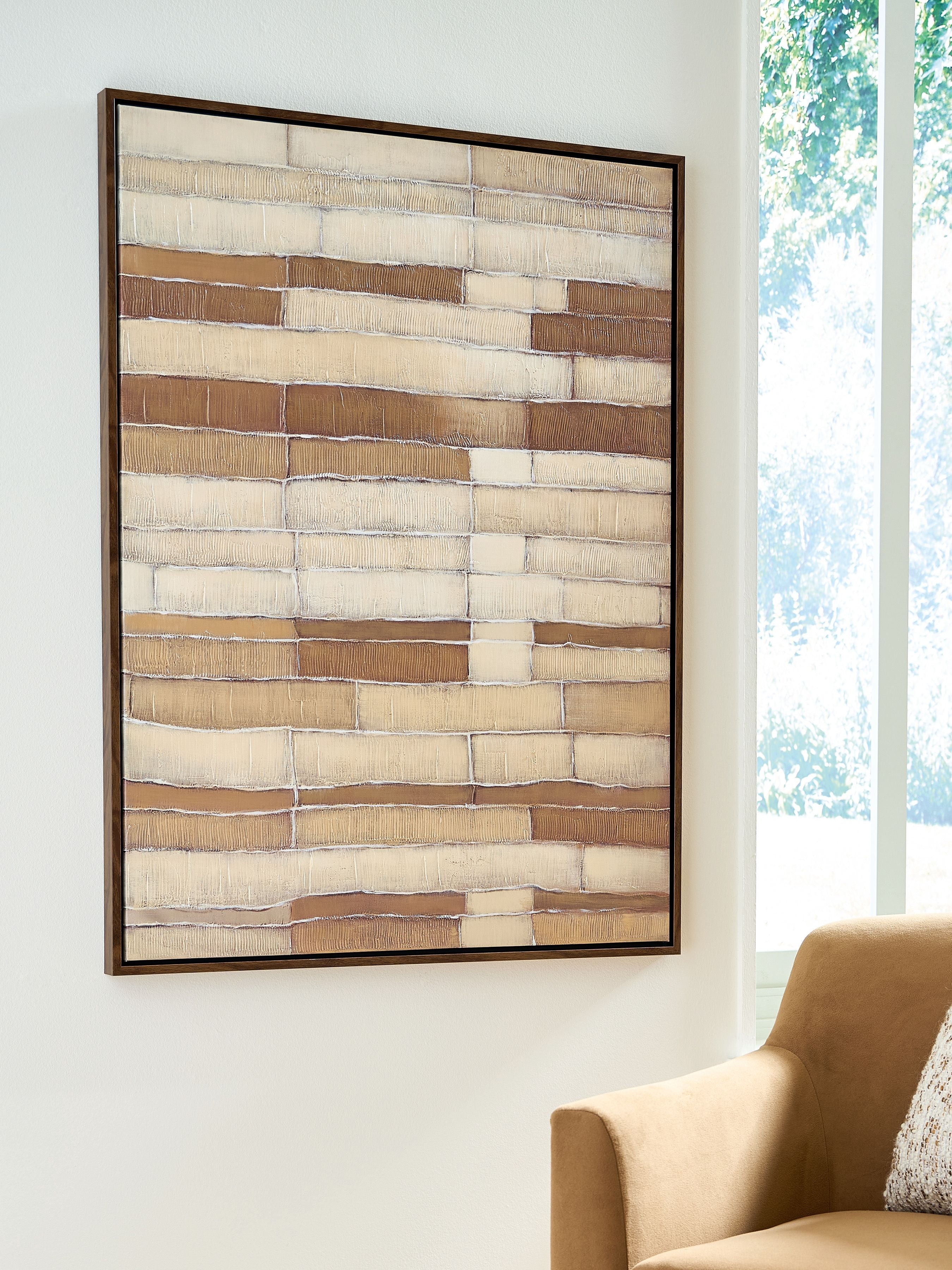Framed wall art with abstract brick-like bands in tan, brown, and white