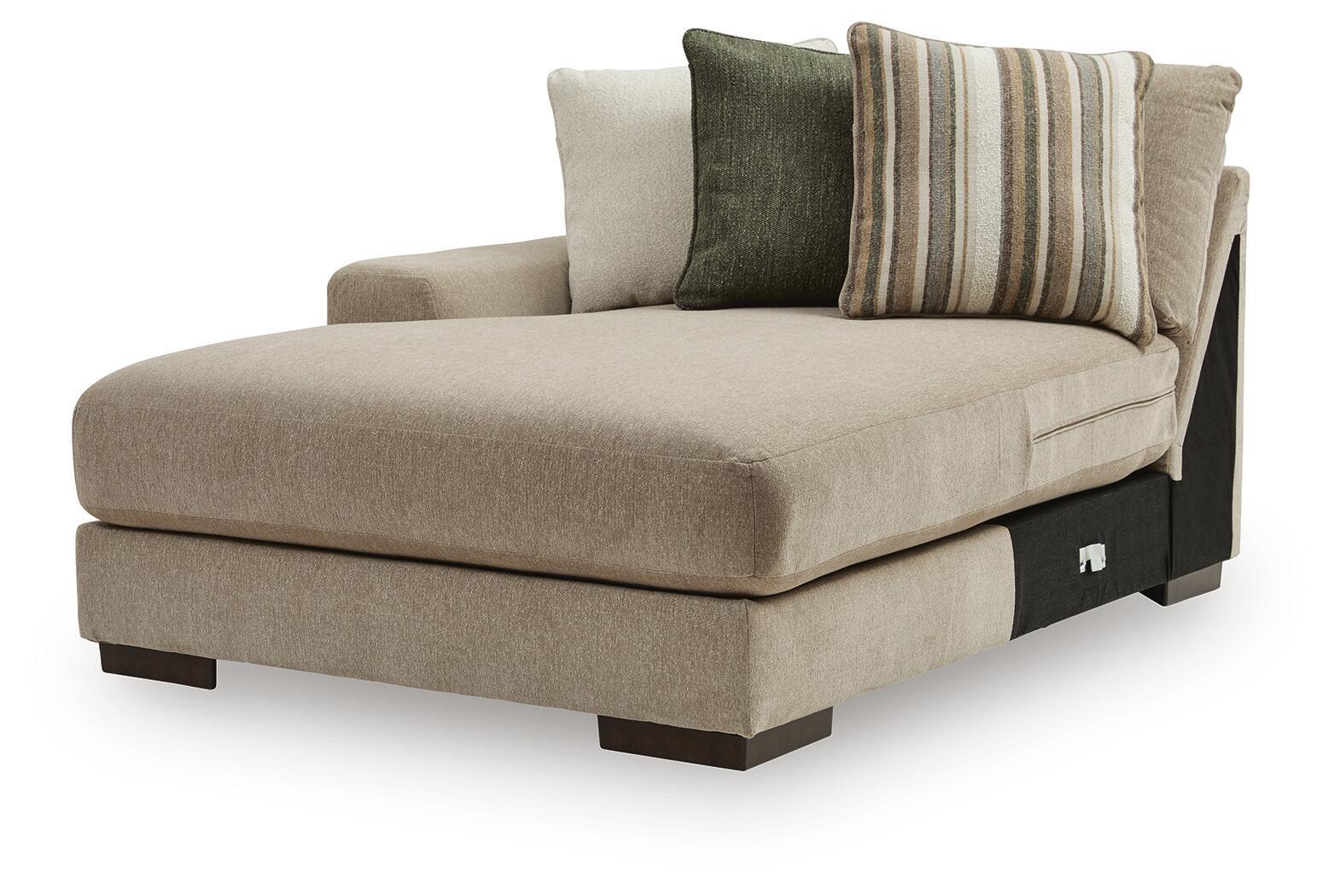 Beige upholstered corner chaise with armrest and green striped throw pillows