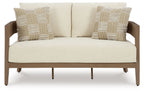 Outdoor lounge loveseat with beige cushions and two patterned pillows, dark wood frame
